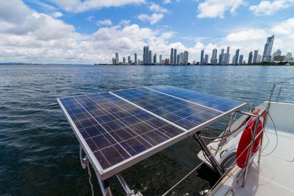 Xem 3 catamaran with its sails lowered floating near mangroves