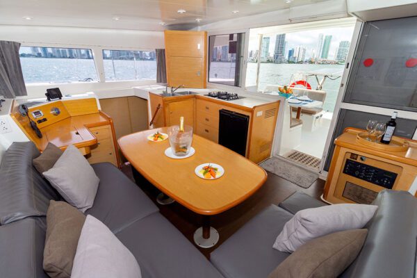 Couple enjoying drinks on the deck of Xem 3 catamaran