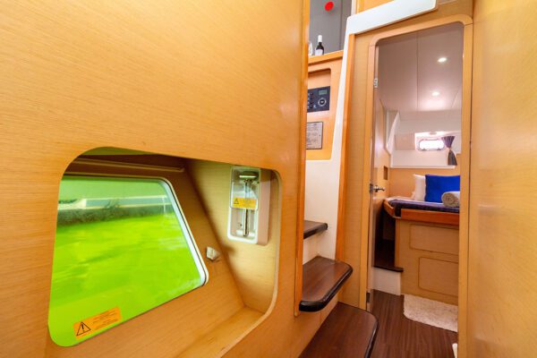 Lagoon 400 catamaran Xem 3 sailing near a tropical beach