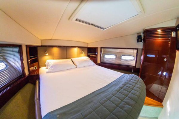 62ft Sea Ray anchored near a white sand beach with crystal clear water