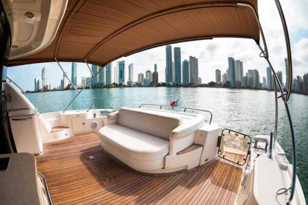Guests sunbathing on the bow of a 62ft Sea Ray yacht