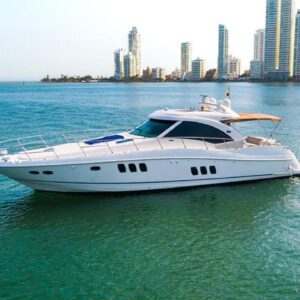 Aerial shot of 62ft Sea Ray cruising near tropical coastline