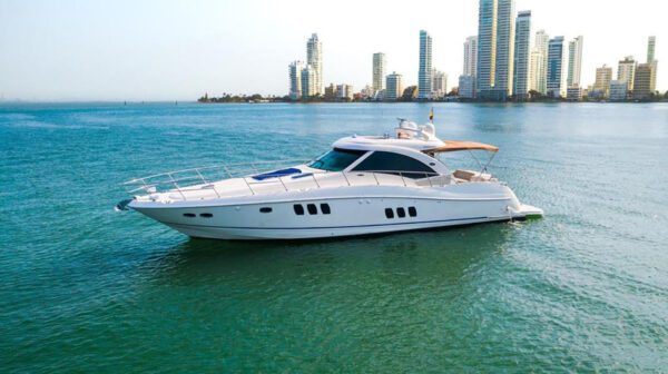 Aerial shot of 62ft Sea Ray cruising near tropical coastline