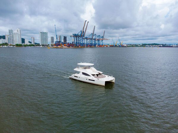 Colombian flag flying on a sleek white catamaran