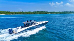 Side view of a fast mini yacht with quad motors.