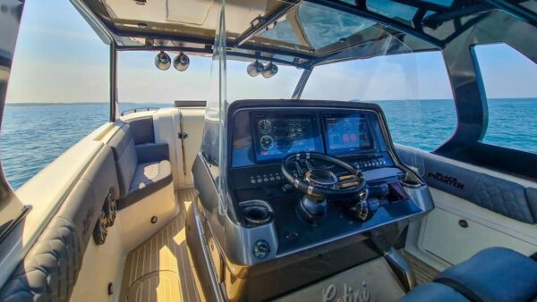 Modern mini yacht with 4 motors and sleek design.