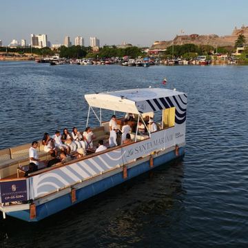 Santa María catamaran in Cartagena Bay with the modern city skyline in the background.
