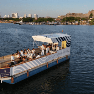 Guests enjoying drinks and sunset views aboard the Santa María catamaran in Cartagena Bay.
